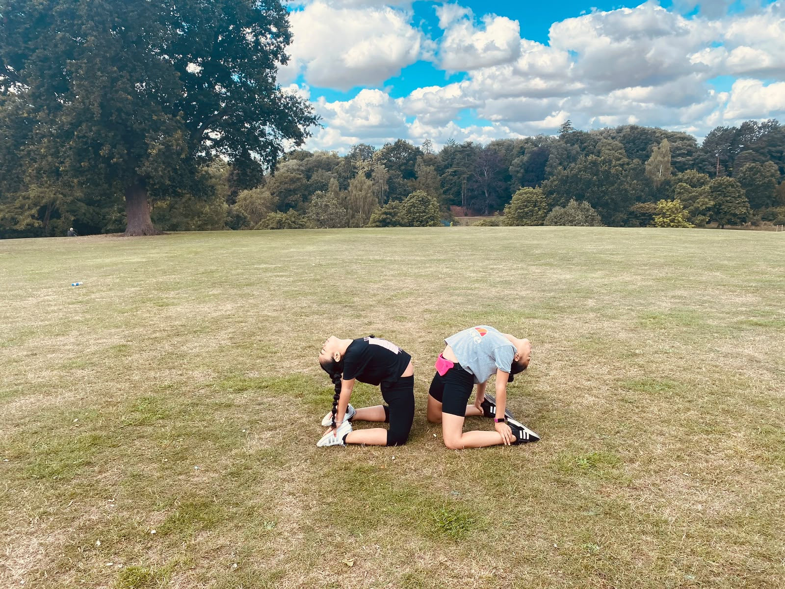Children practising a back bend outdoors